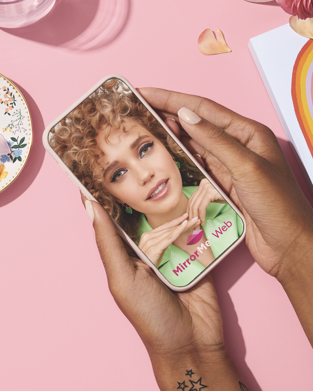 A phone with an image of a woman. The screen reads MirrorMe Web.