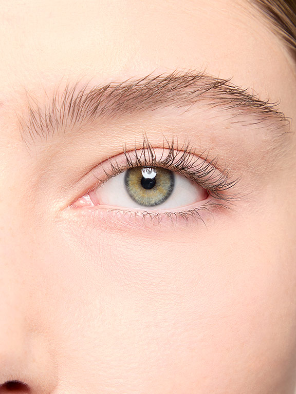 Close up shot of model with light skintone showing eyelashes before mascara application